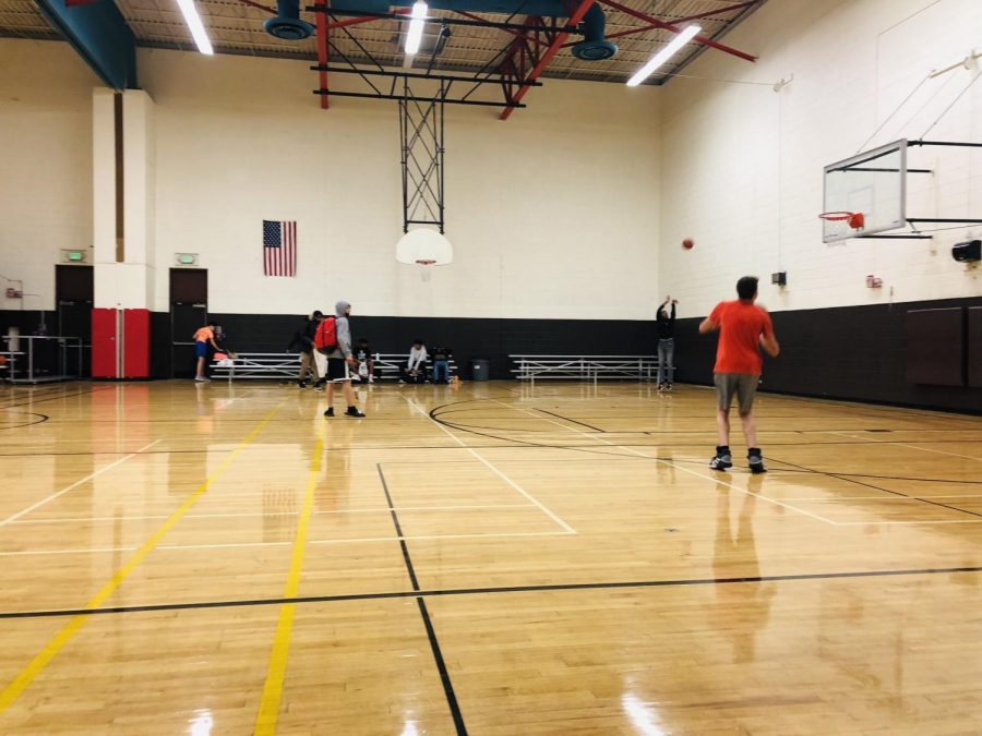 C Squad athletes Playing Basketball In Small Gym
