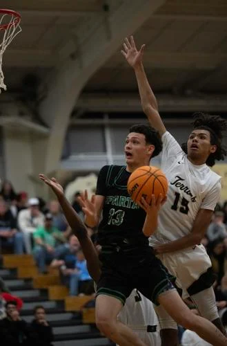 Cohen Collins blocks a basketball shot.  