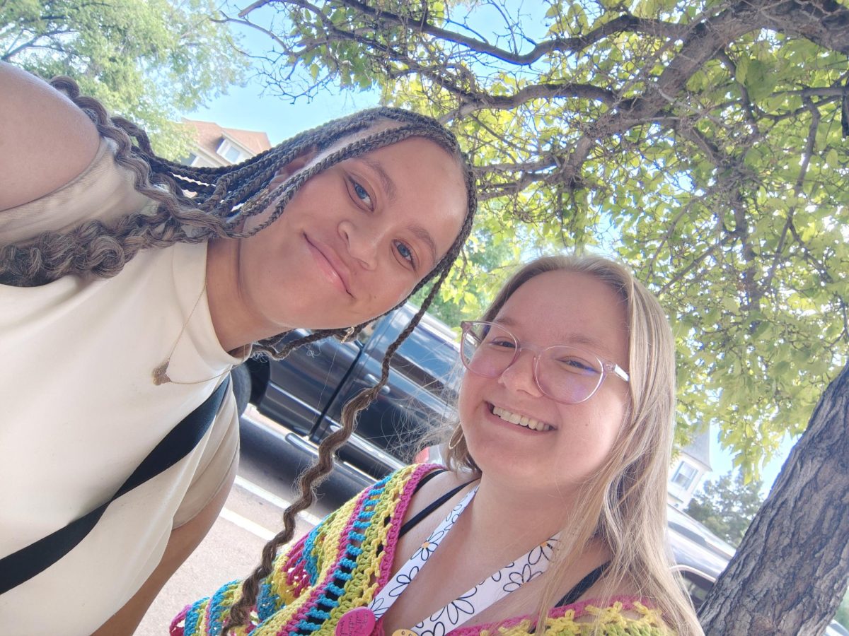 A photo of Cynniah Mack and Mrs. Shoemaker outside of Palmer.