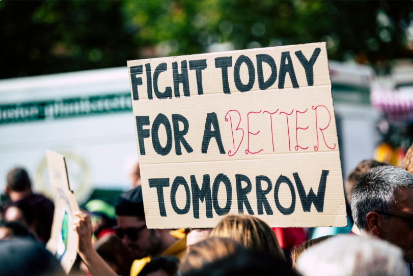 A sign at a protest that says "fight today for a better tomorrow," via Pexels.